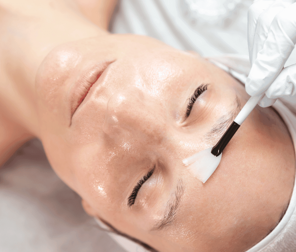 Person receiving a facial treatment with a brush.